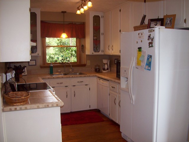 396 Buck Road Gray, GA 31032 - Photo 6 of 36 a kitchen that has a sink a refrigerator and a stove top oven
