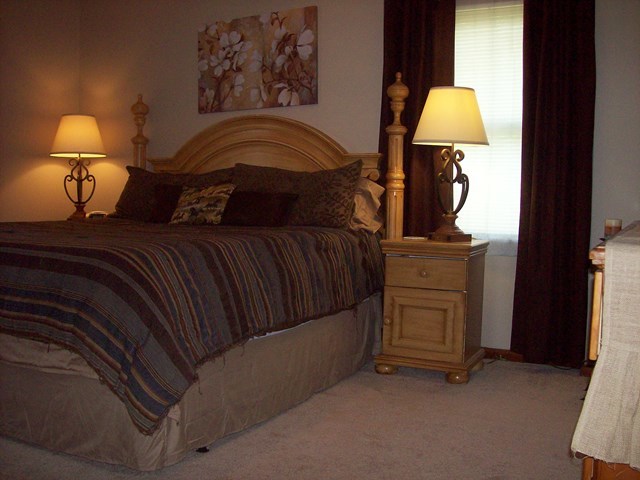 396 Buck Road Gray, GA 31032 - Photo 10 of 36 a bedroom with a bed and a lamp