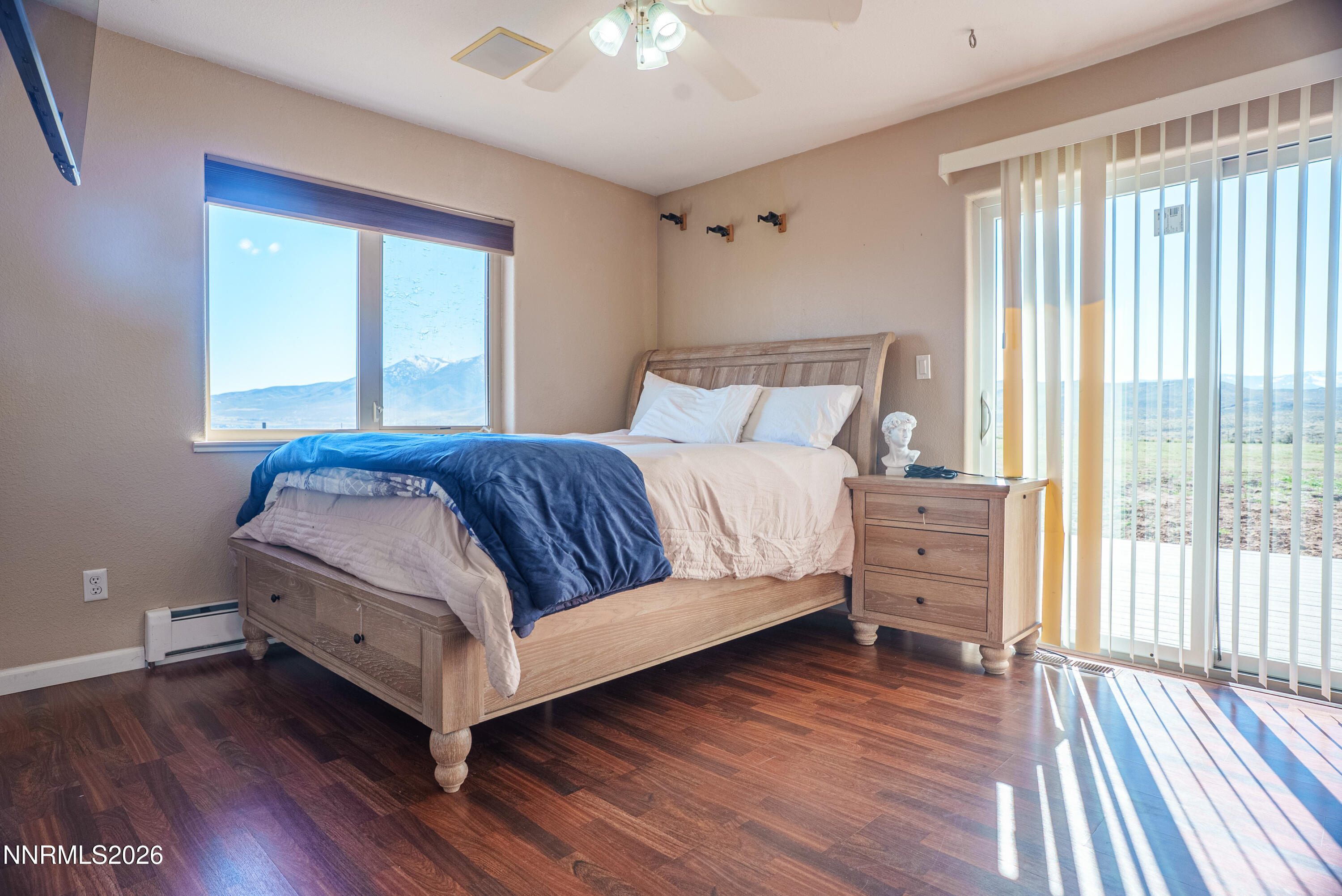 12000 North Red Rock Road Reno, NV 89508 - Photo 12 of 18 a bedroom with a bed and a large window with wooden floor