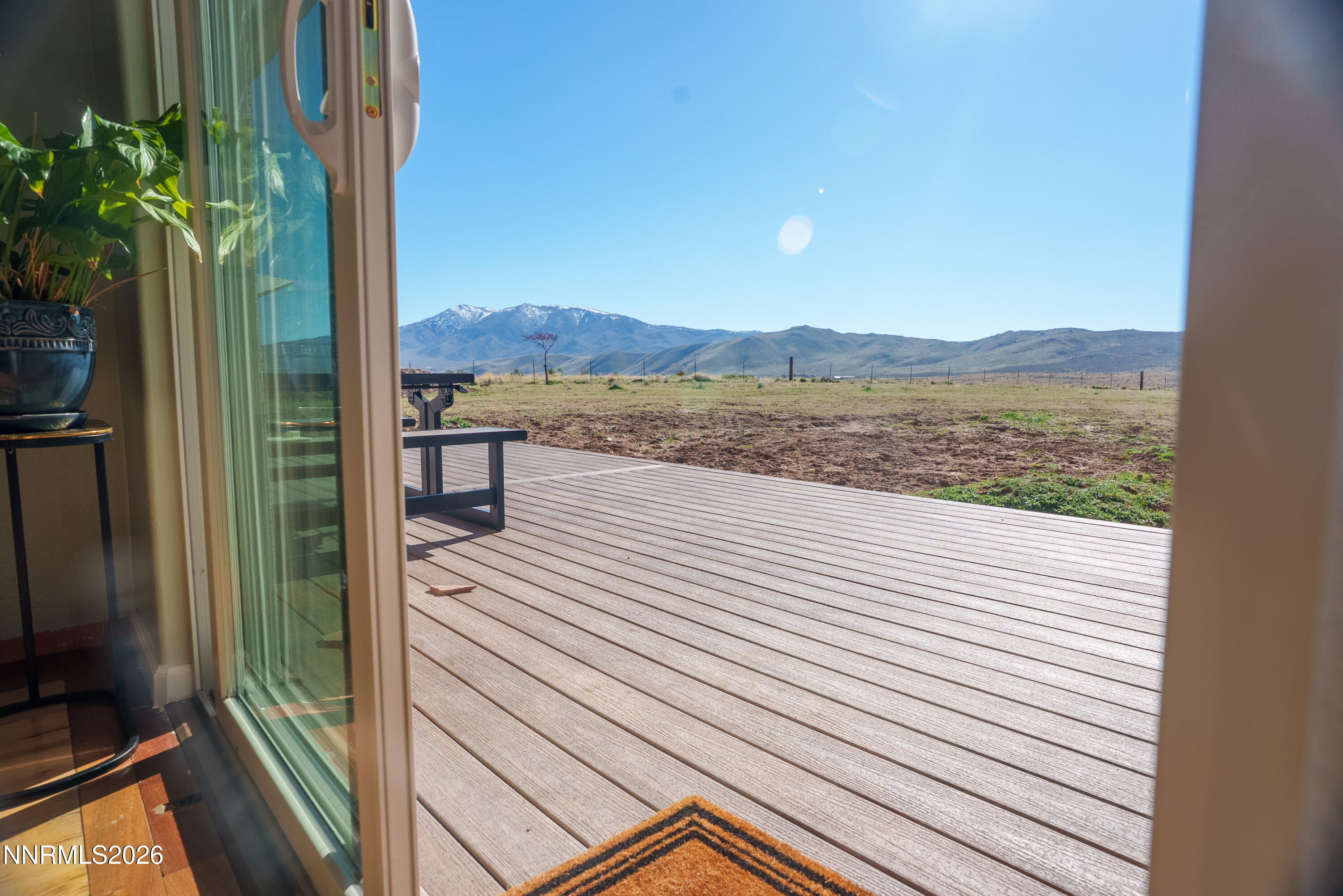 12000 North Red Rock Road Reno, NV 89508 - Photo 8 of 18 a view of a balcony with mountain view and wooden floor