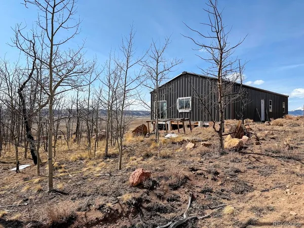 a front view of a house with a yard covered with snow in front of house
