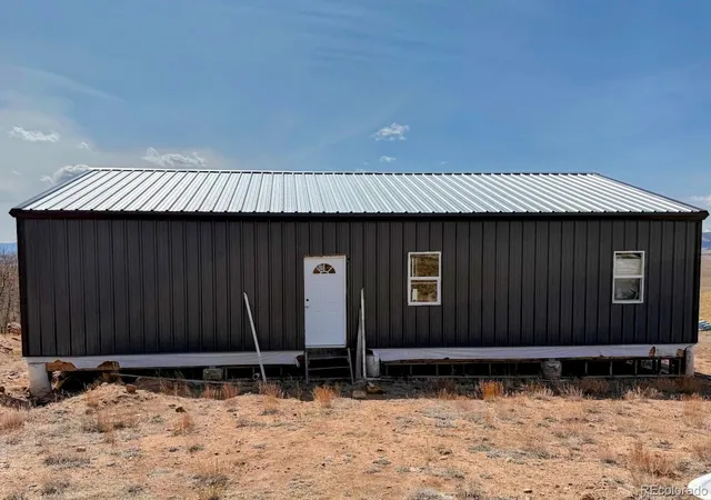 a view of a house with wooden fence
