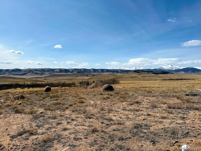 a backyard of a house with barbeque oven table and chairs