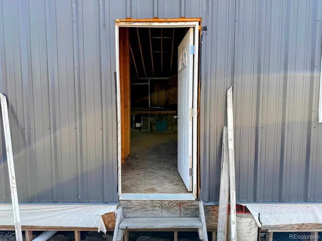 a patio with glass top table and chairs