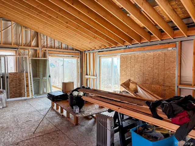 a view of a balcony with chairs and stairs