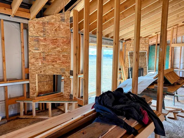 a view of a hallway with wooden chairs