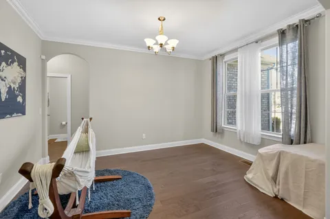 a living room with furniture and a chandelier