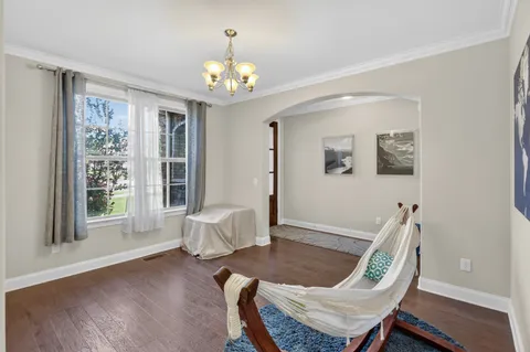 a view of a dining room with furniture wooden floor and chandelier