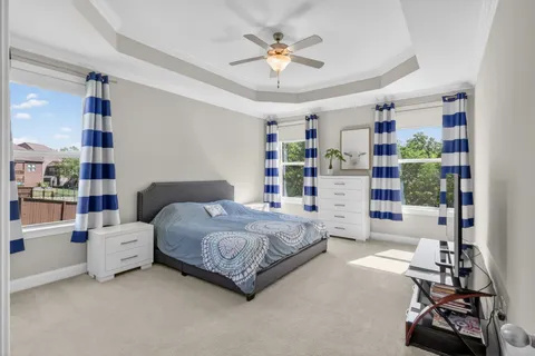 a spacious bedroom with a bed and a chandelier