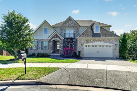 a view of a house with a yard and fence