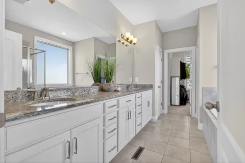 a bathroom with a double vanity sink and a mirror