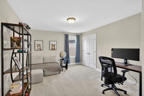 a view of a livingroom with furniture and a workspace