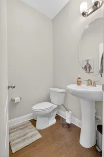 a bathroom with a sink toilet and a mirror