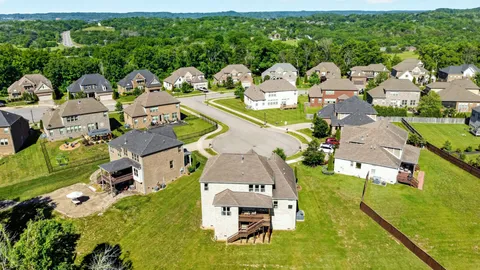 an aerial view of multiple houses with yard