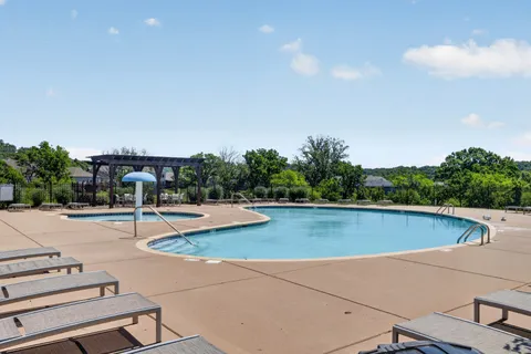 a view of a swimming pool with lounge chair