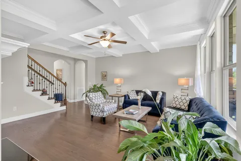 a living room with furniture dining table a chandelier and a chandelier
