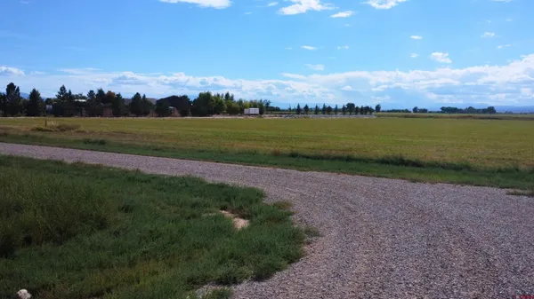 a view of a lake with sunset in background