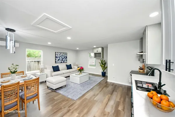 a living room with furniture and wooden floor