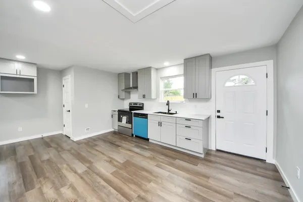 a view of a kitchen with white cabinets