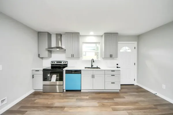 a kitchen with stainless steel appliances a sink stove and cabinets