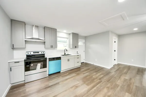 a kitchen with granite countertop a stove and a sink