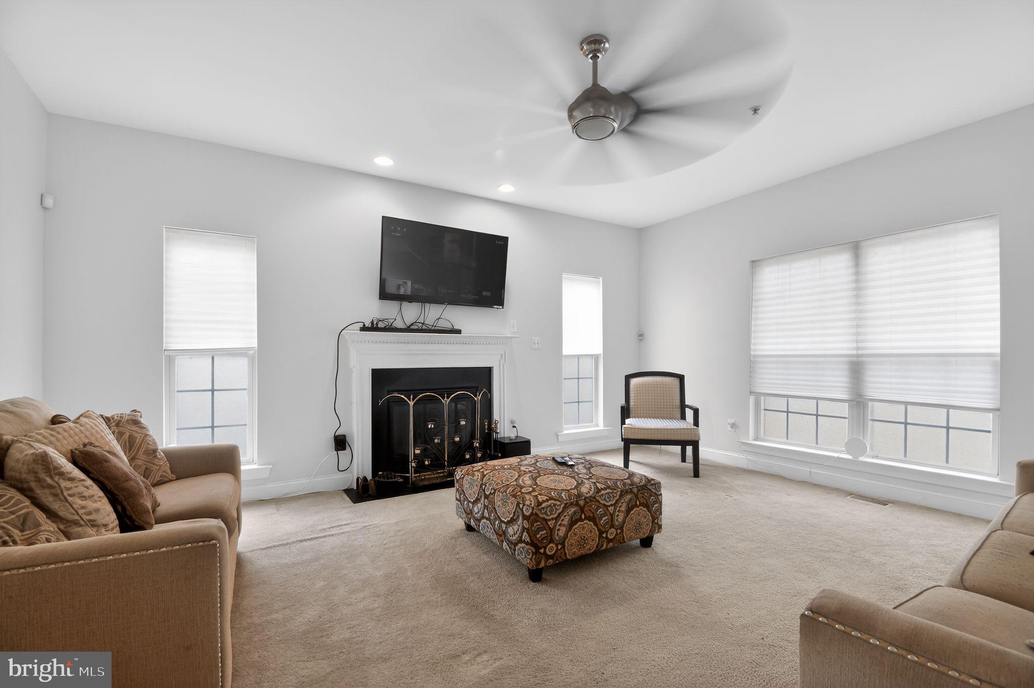 9009 Eldon Drive Clinton, MD 20735 - Photo 11 of 40 a living room with furniture a fireplace and a flat screen tv