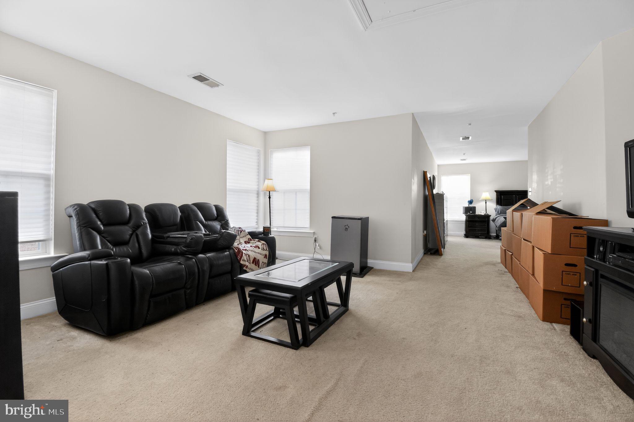 9009 Eldon Drive Clinton, MD 20735 - Photo 12 of 40 a living room with furniture and a flat screen tv
