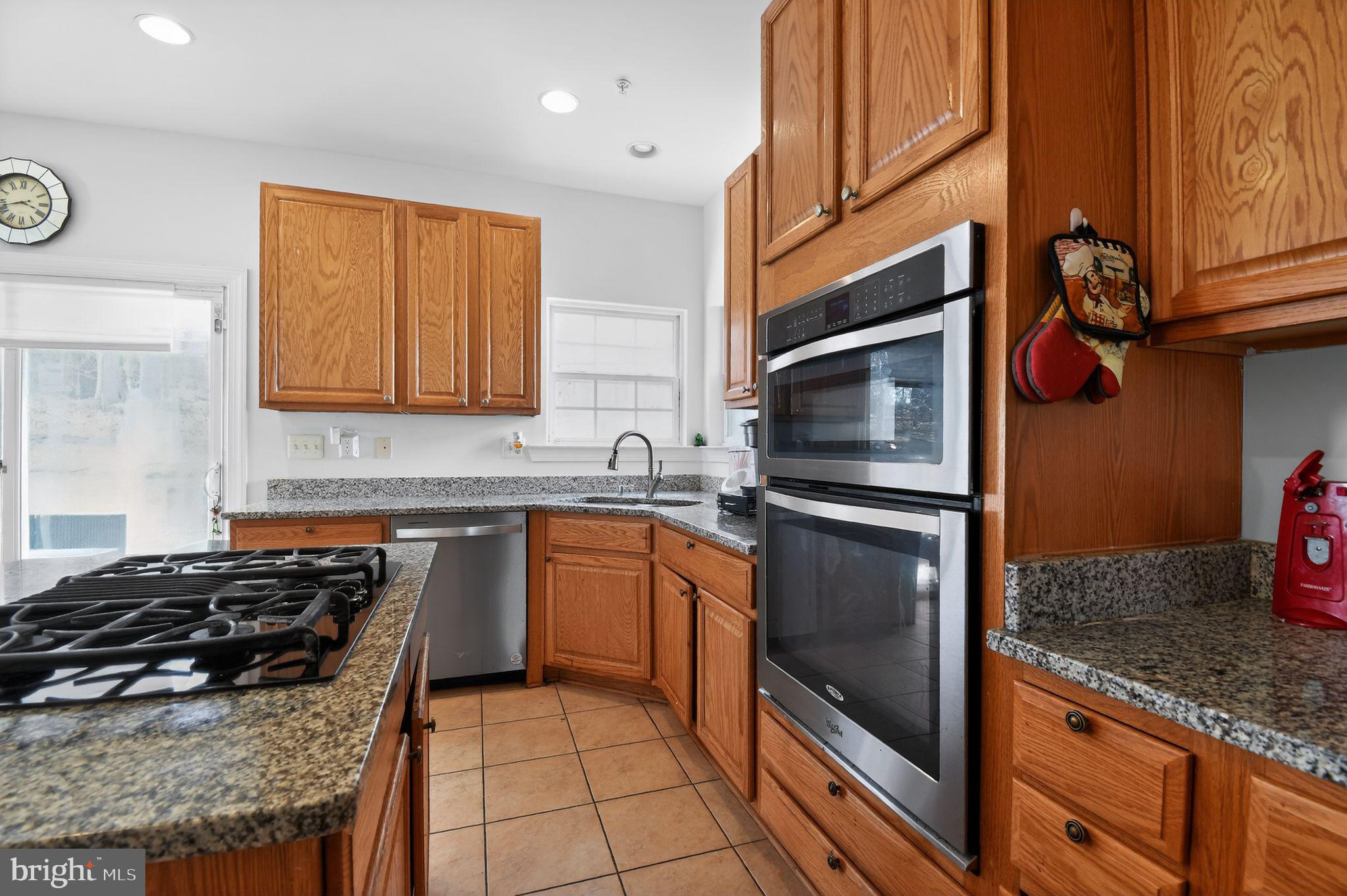 9009 Eldon Drive Clinton, MD 20735 - Photo 13 of 40 a kitchen with granite countertop stainless steel appliances and wooden cabinets