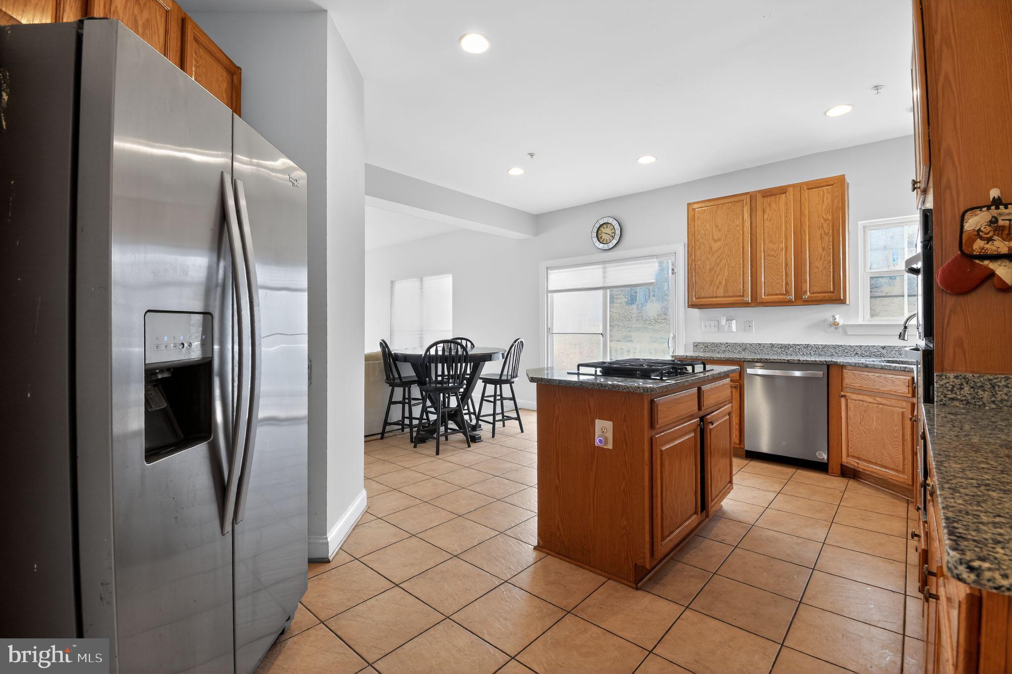 9009 Eldon Drive Clinton, MD 20735 - Photo 14 of 40 a kitchen with stainless steel appliances granite countertop a refrigerator and a stove