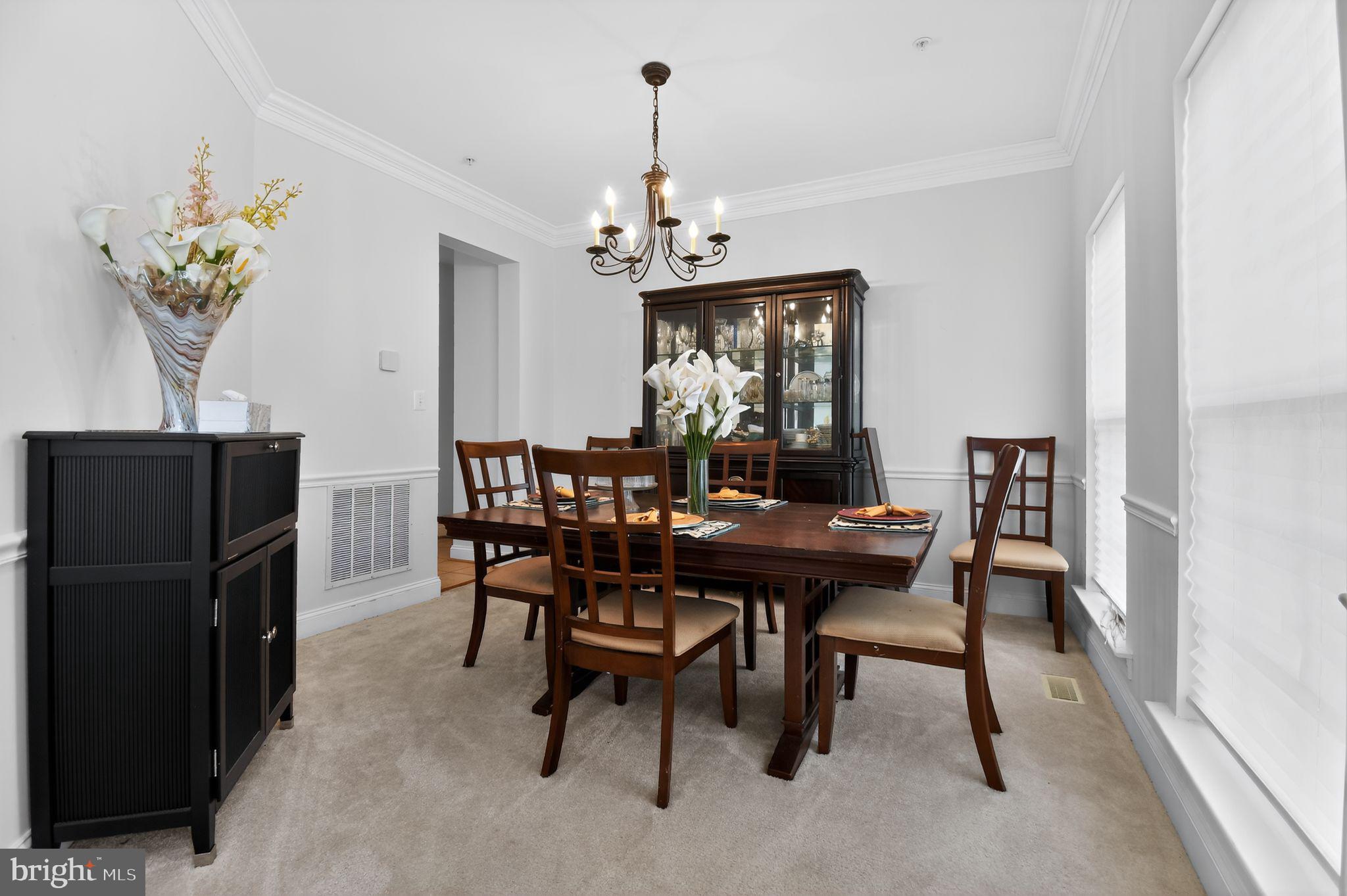 9009 Eldon Drive Clinton, MD 20735 - Photo 19 of 40 a view of a dining room with furniture wooden floor and a chandelier