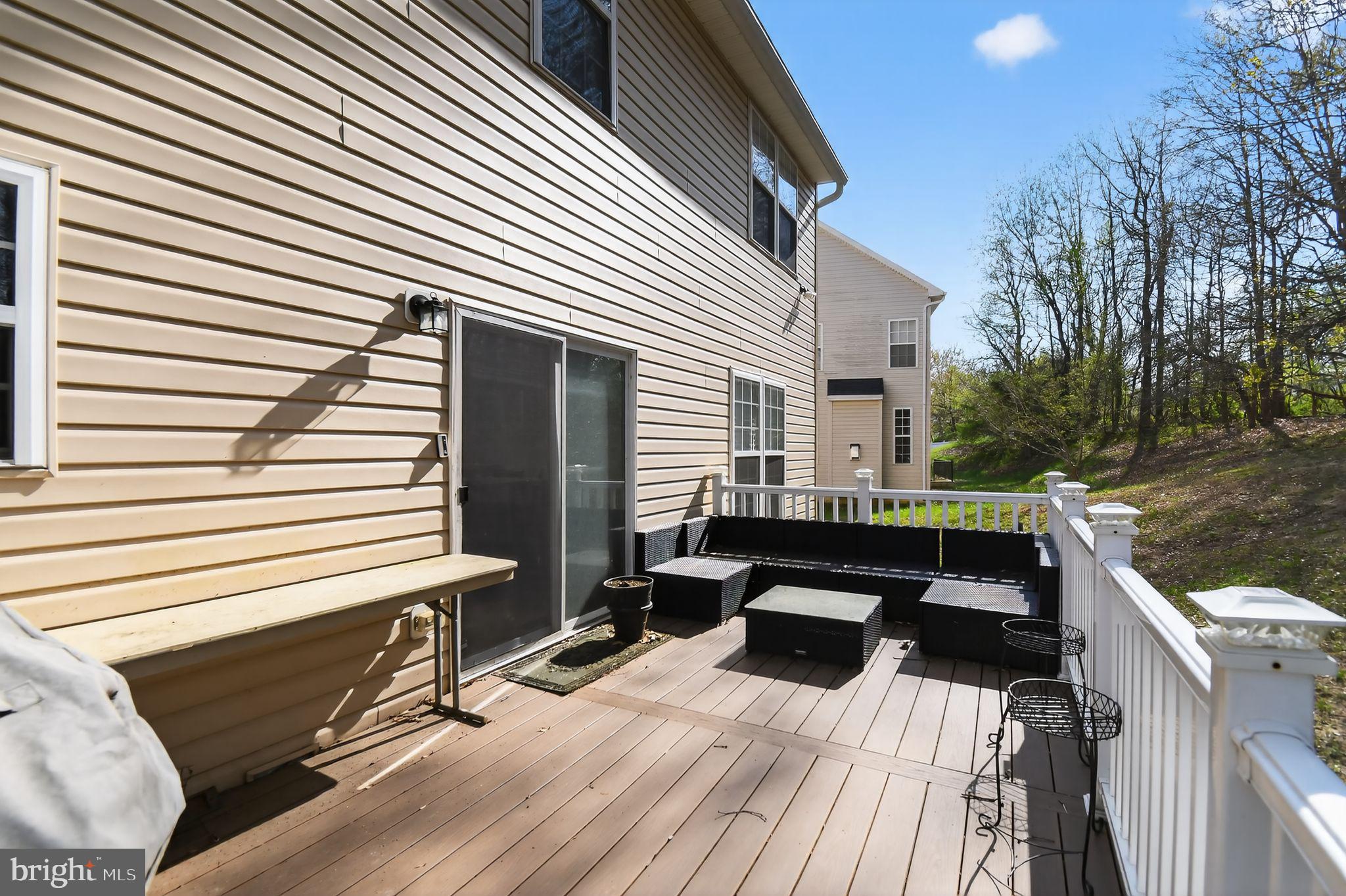 9009 Eldon Drive Clinton, MD 20735 - Photo 2 of 40 a view of a patio with couches chairs and wooden floor