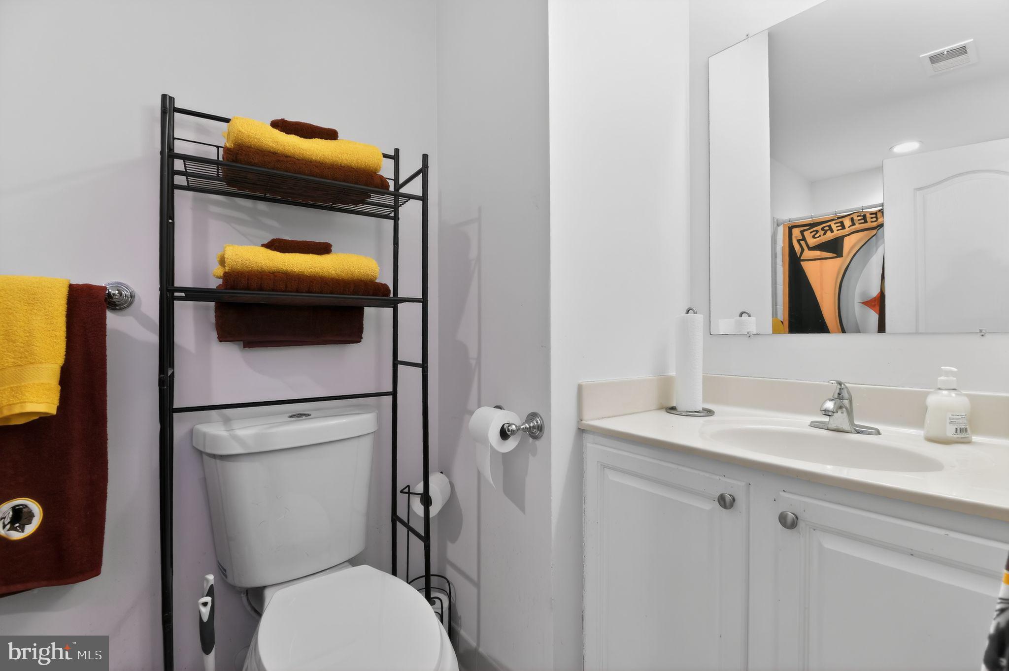 9009 Eldon Drive Clinton, MD 20735 - Photo 26 of 40 a bathroom with a toilet sink and mirror