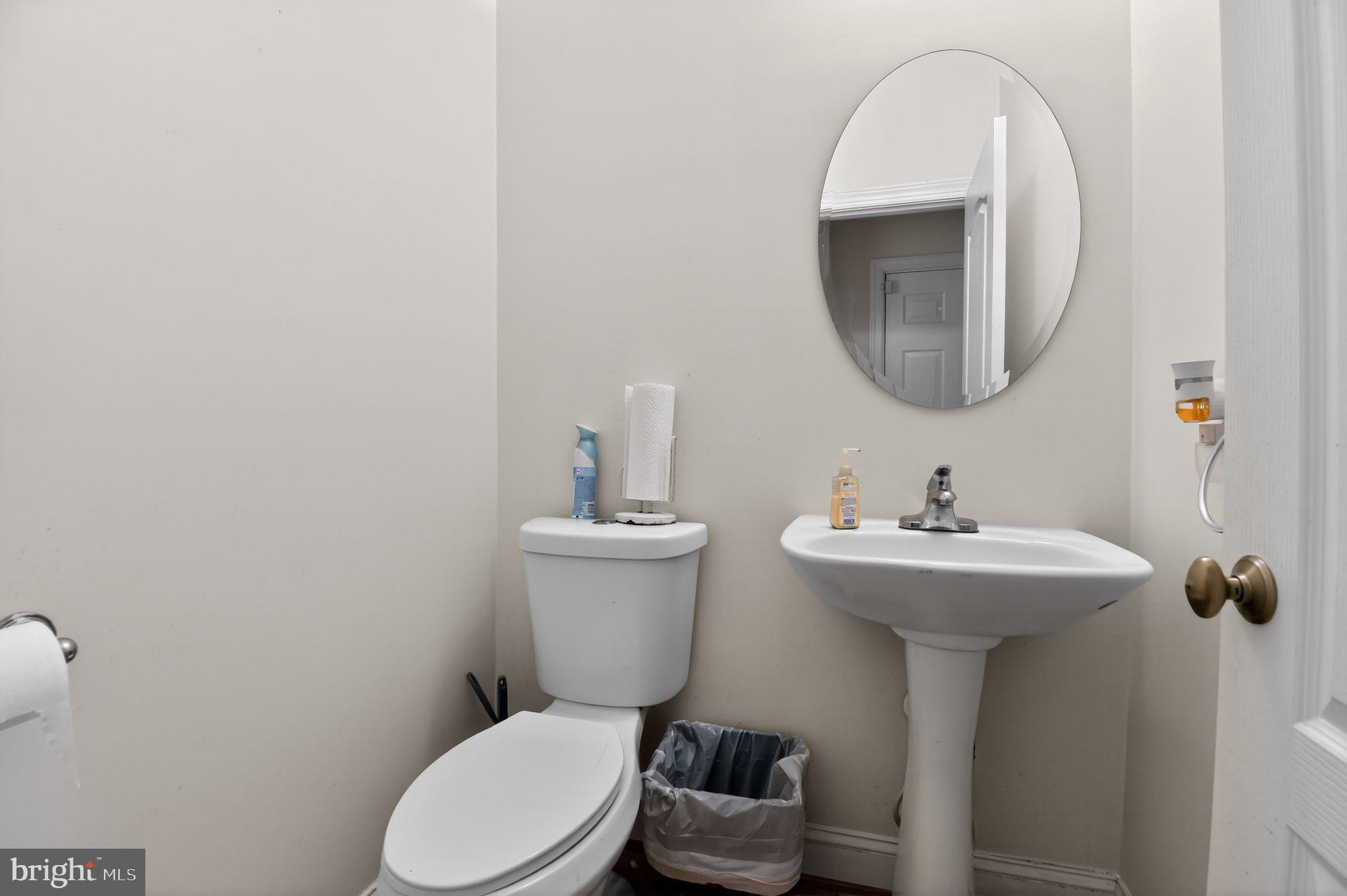 9009 Eldon Drive Clinton, MD 20735 - Photo 27 of 40 a bathroom with a toilet sink and mirror