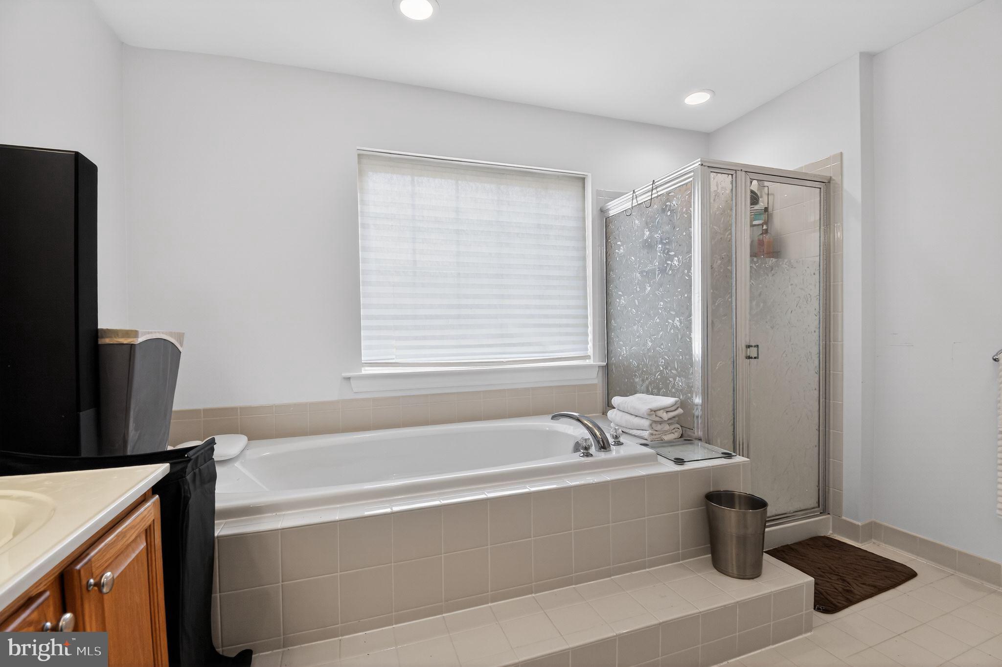 9009 Eldon Drive Clinton, MD 20735 - Photo 29 of 40 a bathroom with a bathtub and a shower