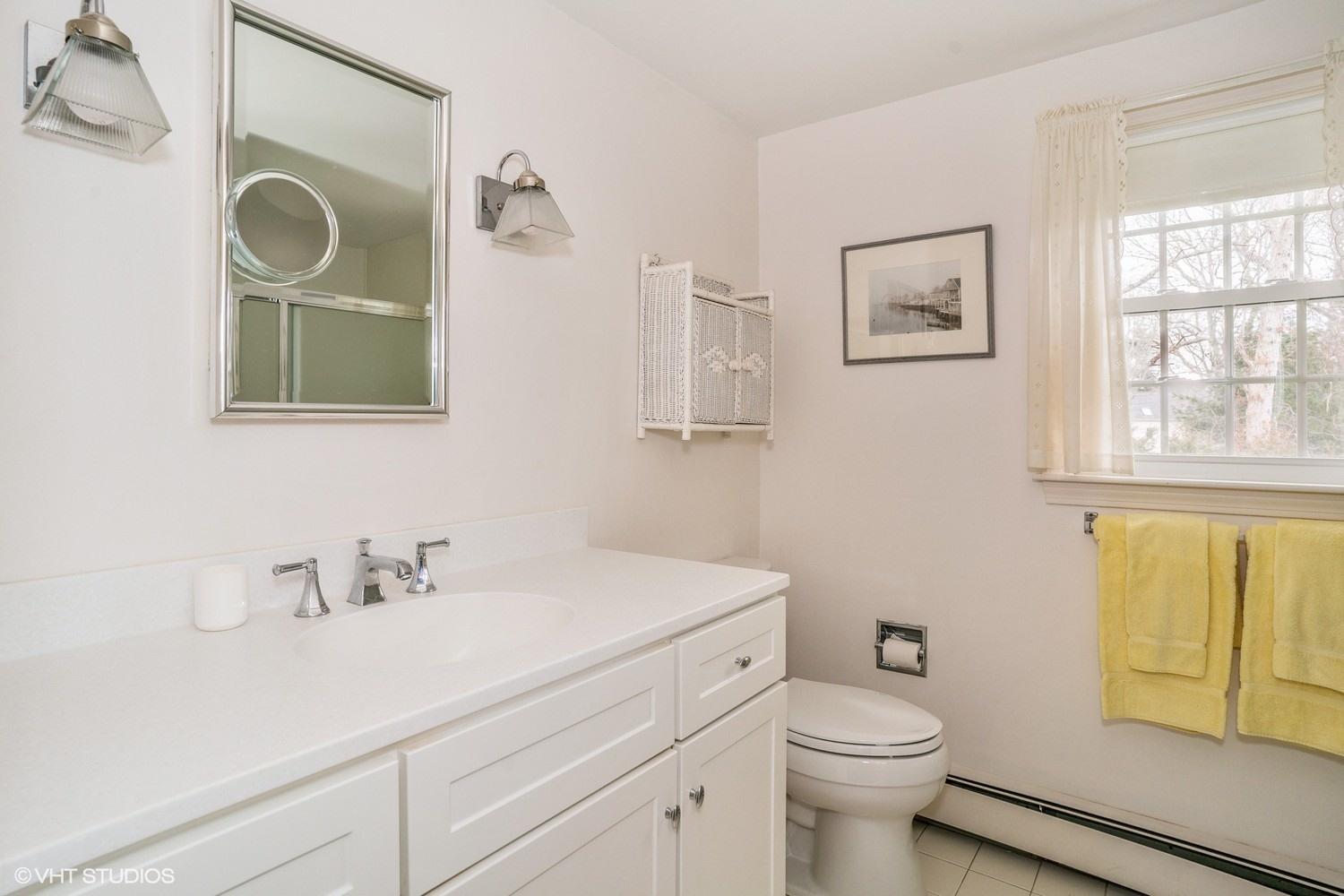 50 Deerfield Road Osterville, MA 02655 - Photo 13 of 14 a bathroom with a sink a toilet and a mirror