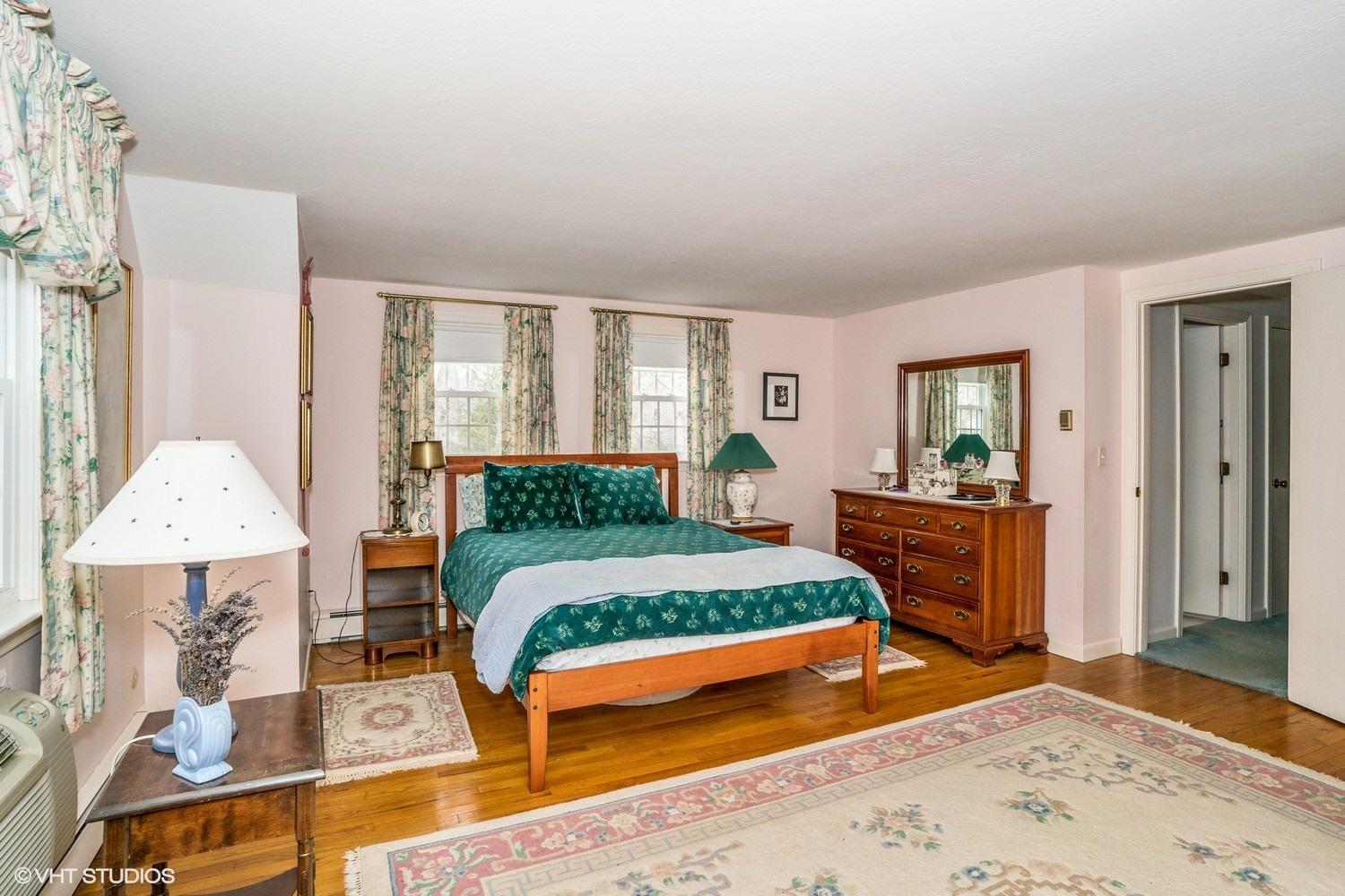 50 Deerfield Road Osterville, MA 02655 - Photo 10 of 14 a bedroom with a bed lamps and wooden floor