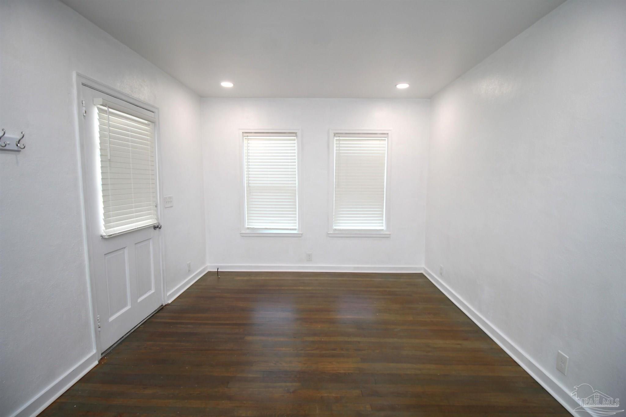 315 Flannan Road Pensacola, FL 32507 - Photo 5 of 17 an empty room with wooden floor and windows