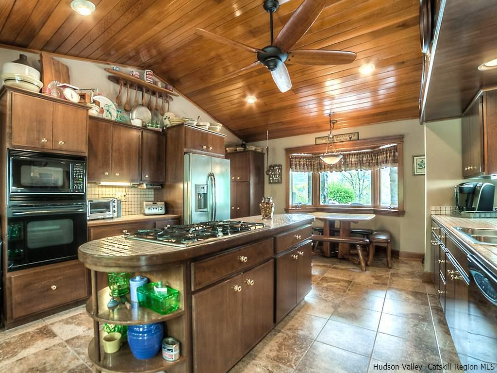 47 Saddleback Ridge Road Wallkill, NY 12589 - Photo 18 of 32 a kitchen with stainless steel appliances granite countertop a sink and wooden cabinets