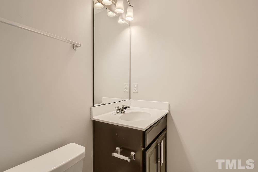 2557 Rambling Creek Road Apex, NC 27523 - Photo 20 of 27 a bathroom with a sink a toilet and shower