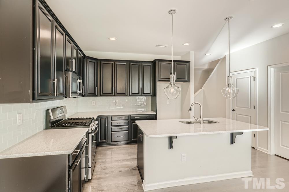 2557 Rambling Creek Road Apex, NC 27523 - Photo 8 of 27 a kitchen with a sink and stove