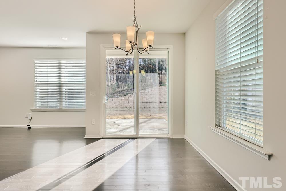 2557 Rambling Creek Road Apex, NC 27523 - Photo 10 of 27 a view of a livingroom with a large window and chandelier