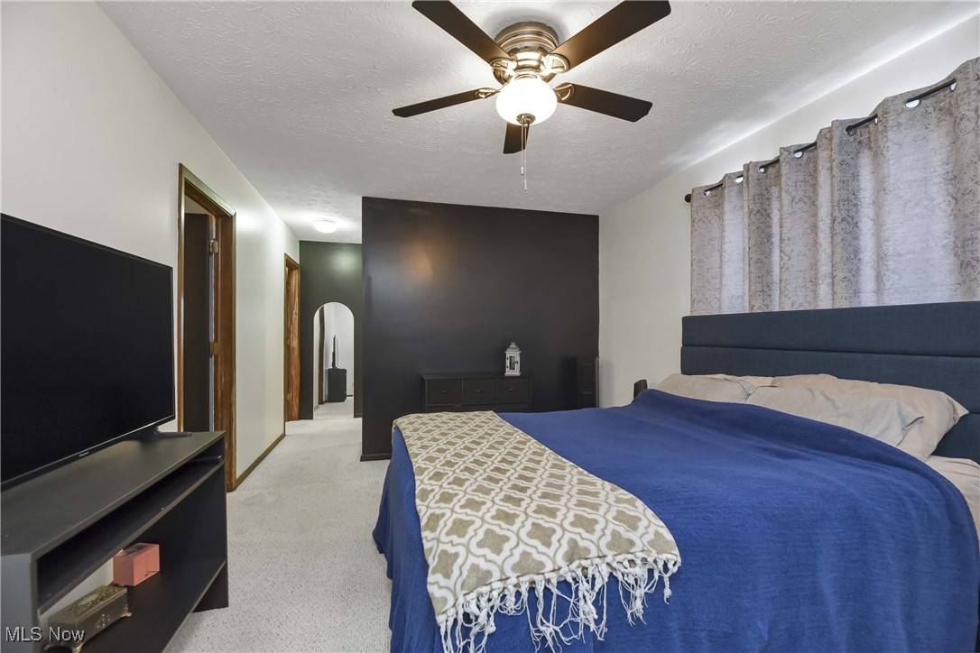 10778 Gate Post Road Strongsville, OH 44149 - Photo 30 of 40 Carpeted bedroom with ceiling fan and a textured ceiling