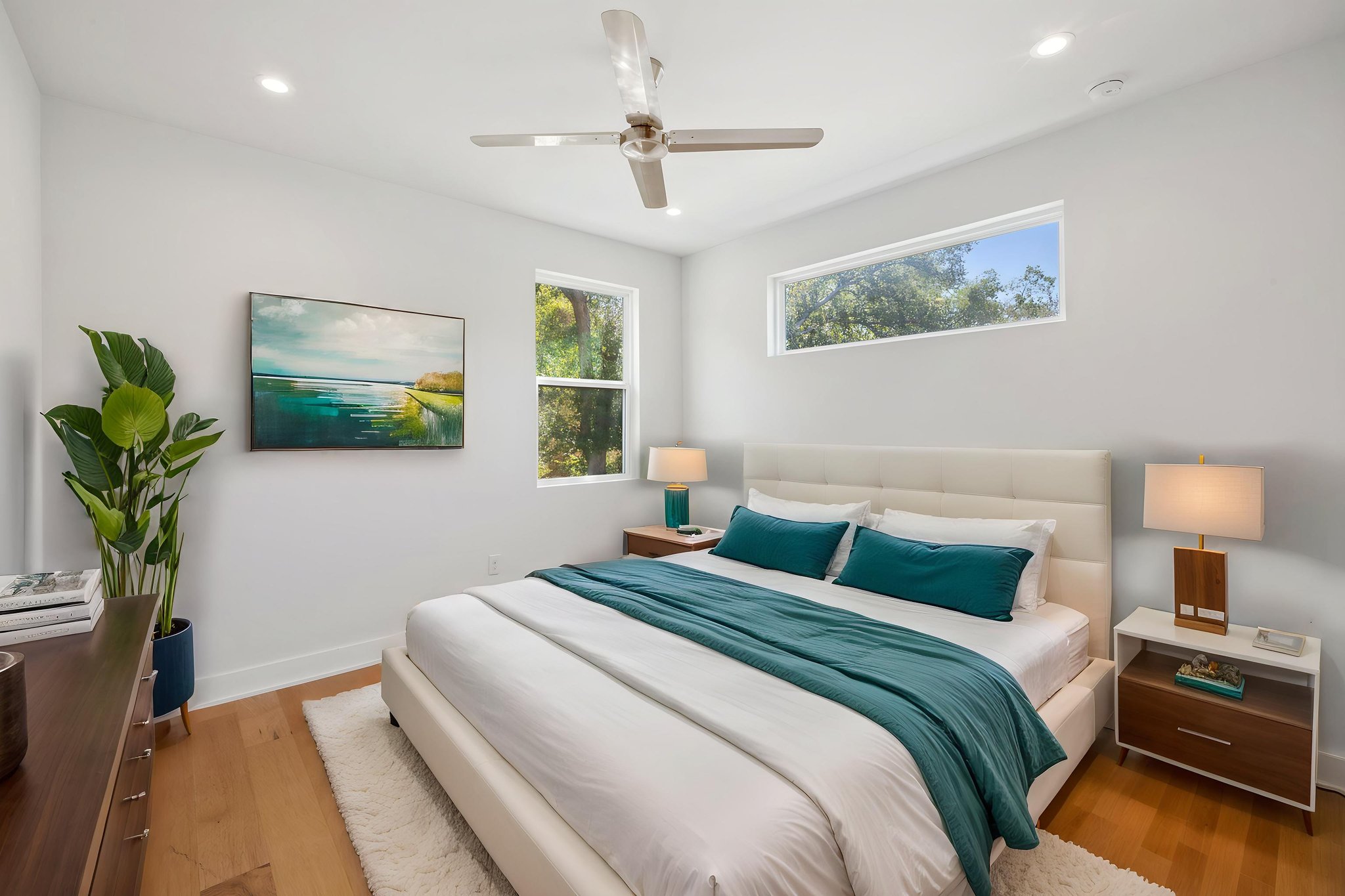 1719 Bunche Road Austin, TX 78721 - Photo 25 of 36 Recessed lighting and wide wood planks enrich this airy bedroom design.