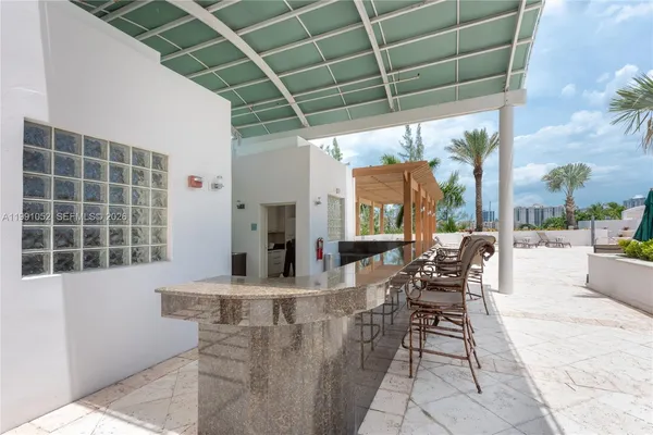 a view of a swimming pool with a patio and a yard