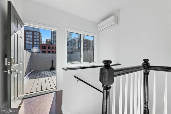a view of a hallway with a window and furniture