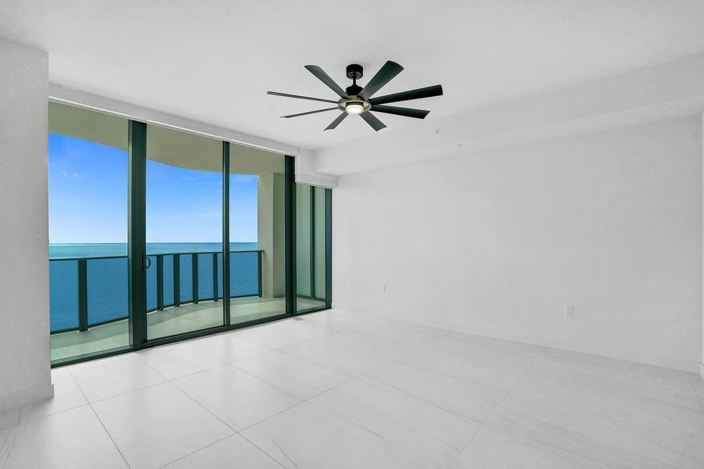 900 North Ocean Boulevard, Unit 1405 Pompano Beach, FL 33062 - Photo 13 of 59 a view of a livingroom with a ceiling fan and window