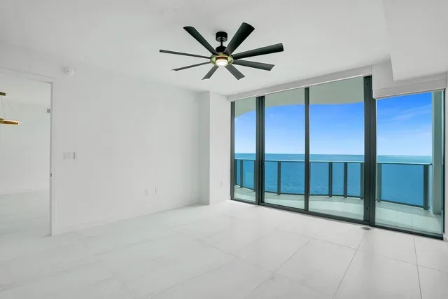 a view of a livingroom with a ceiling fan and window