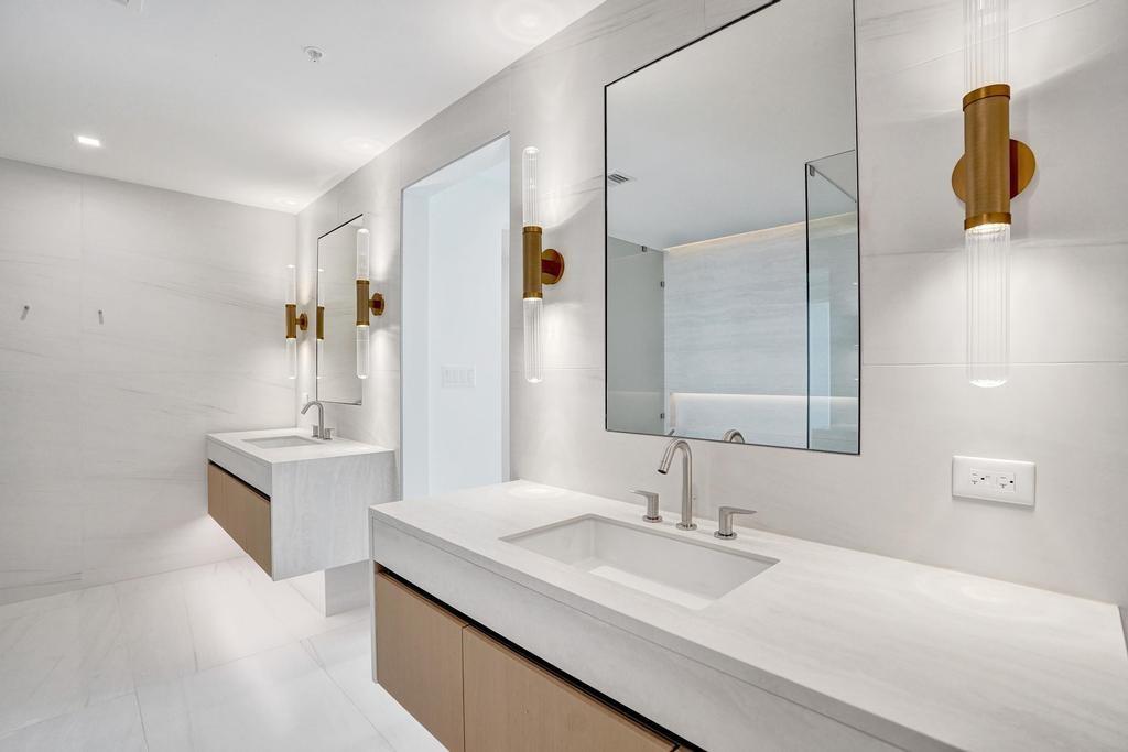 900 North Ocean Boulevard, Unit 1405 Pompano Beach, FL 33062 - Photo 18 of 59 a bathroom with a sink and a mirror