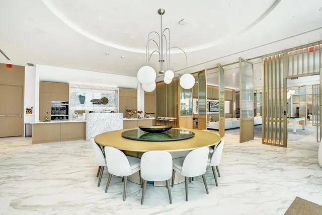 a view of a swimming pool with a lawn chairs under palm trees