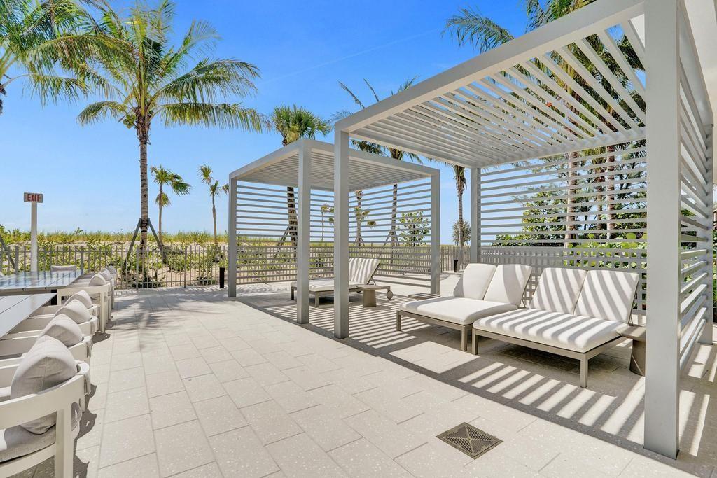 900 North Ocean Boulevard, Unit 1405 Pompano Beach, FL 33062 - Photo 48 of 59 a row of pool with outdoor seating